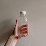 a hand holding a bottle